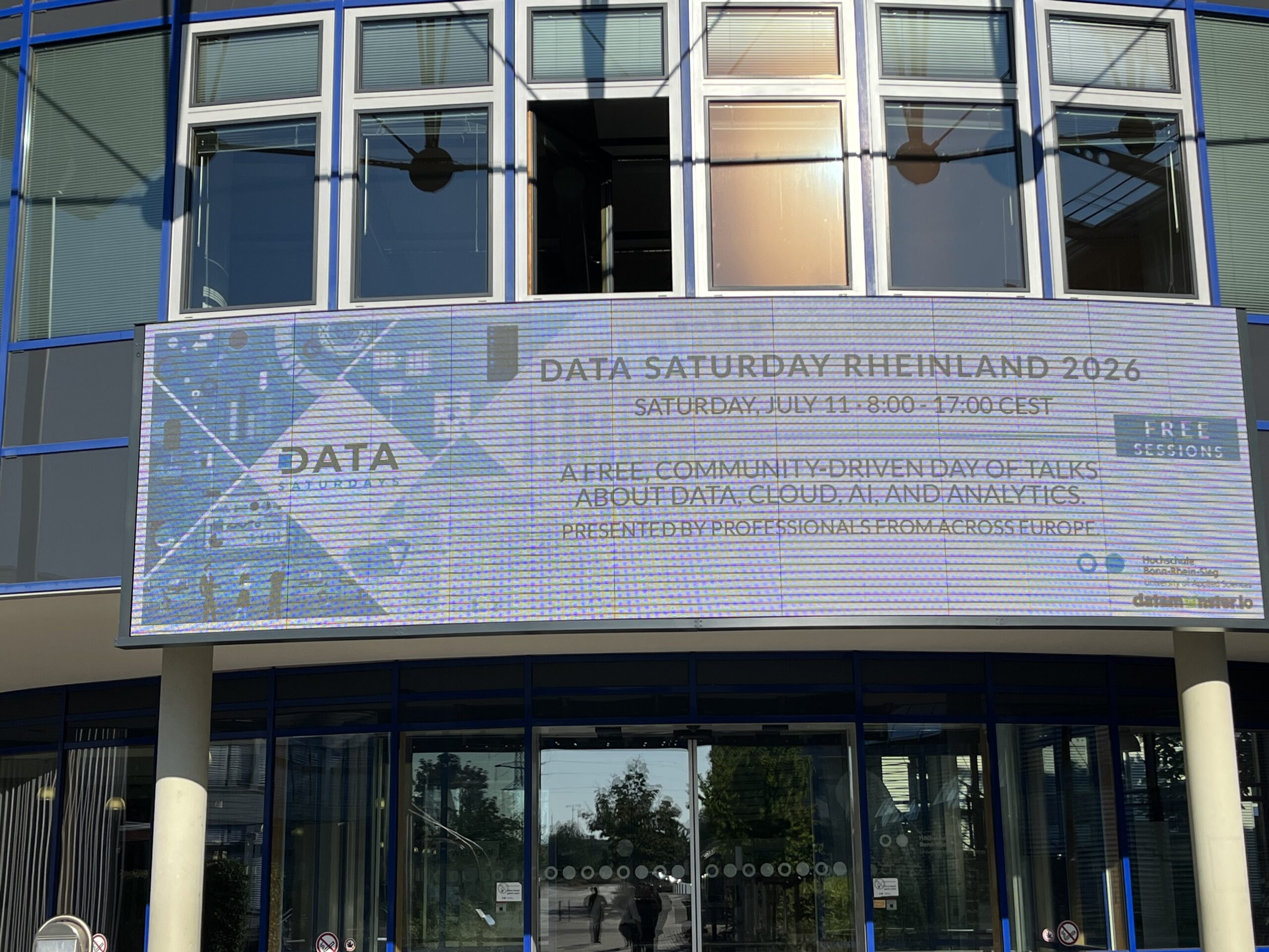 Large digital display at the entrance of Data Saturday Rheinland 2026 showing the event announcement at Hochschule Bonn-Rhein-Sieg.