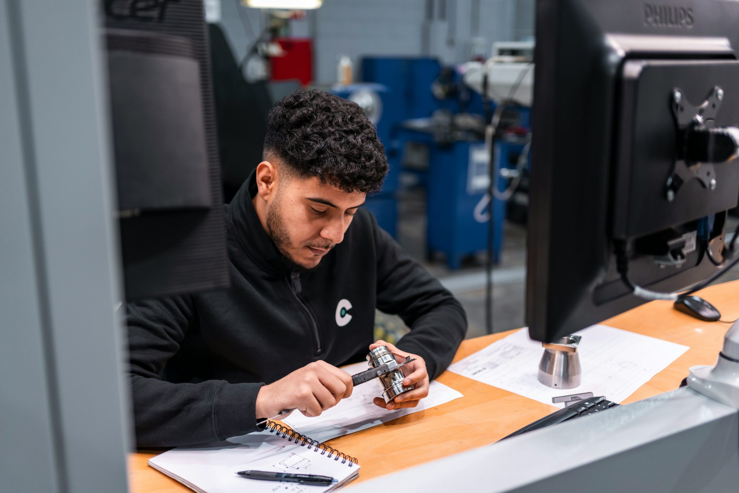 Engineer measuring a precision component at a technical workstation, illustrating production readiness for SQL Server vector search.