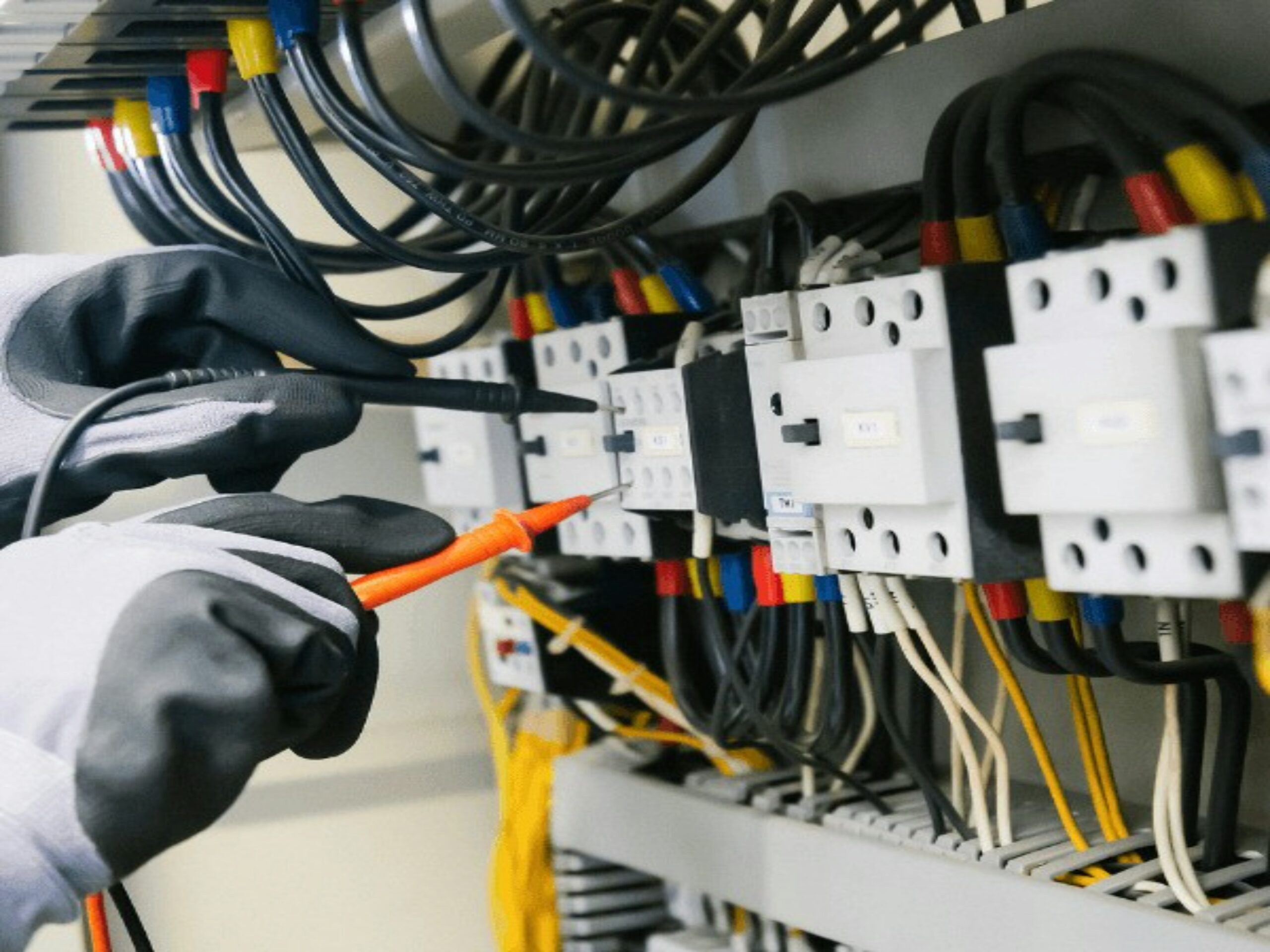 Technician reviewing existing wiring before changes, representing historical SQL Server permissions and dependencies