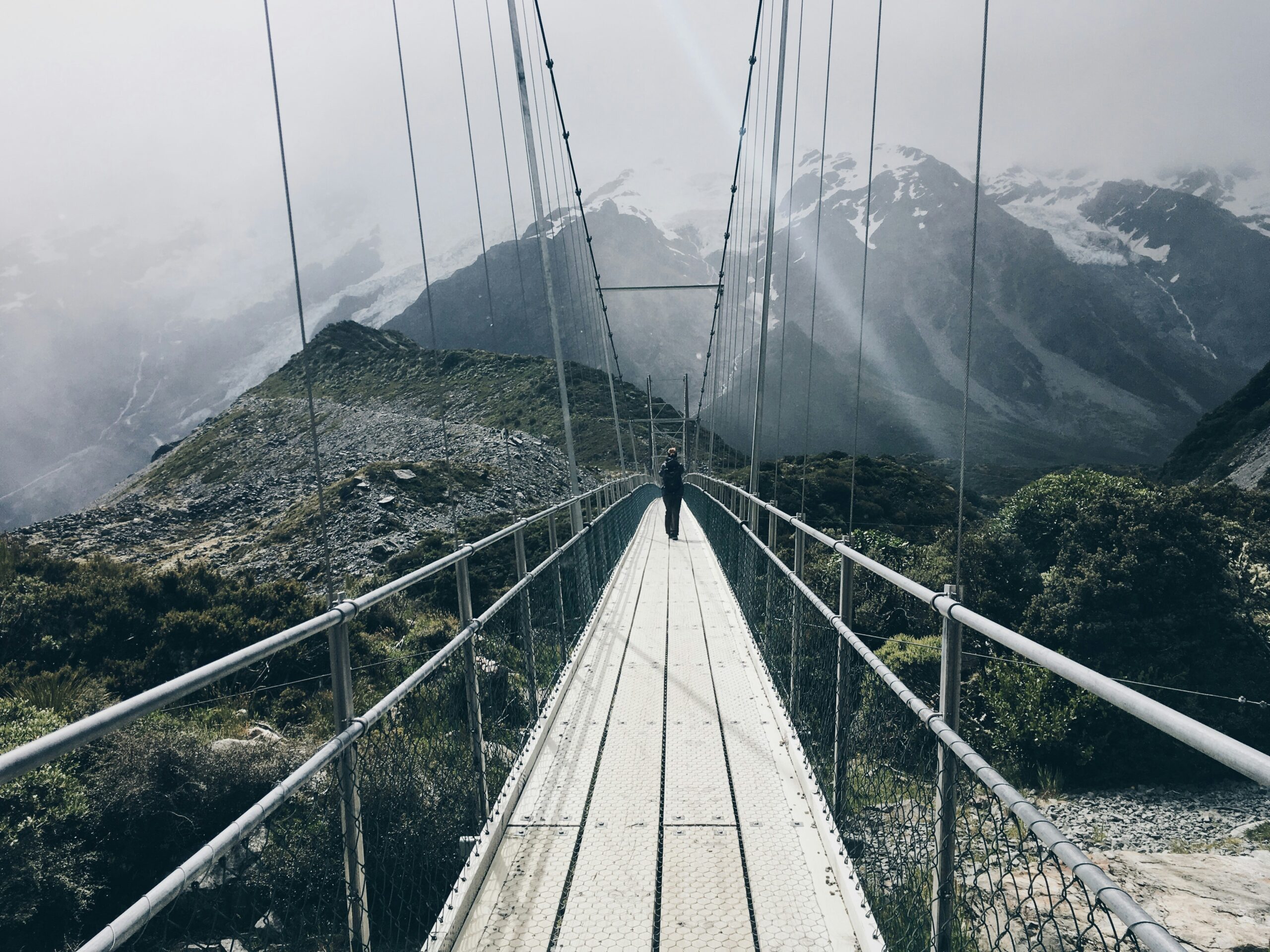 Suspension bridge leading through a mountain landscape, representing SQL Server restore validation and service recovery